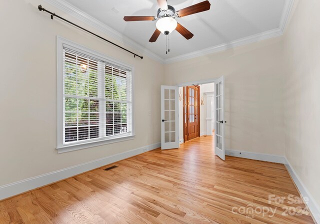 spare room with ceiling fan, french doors, light hardwood / wood-style floors, and ornamental molding