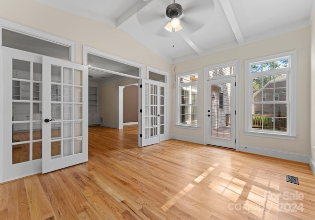 unfurnished sunroom featuring vaulted ceiling with beams, ceiling fan, and french doors