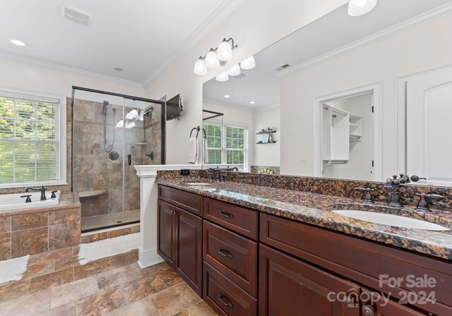 bathroom with shower with separate bathtub, plenty of natural light, and crown molding