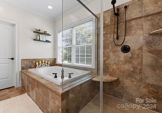 bathroom with crown molding and shower with separate bathtub