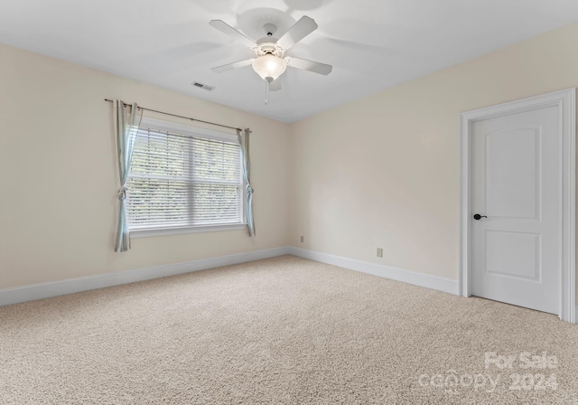 empty room featuring carpet floors and ceiling fan