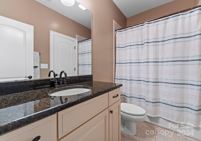 bathroom with tile patterned flooring, vanity, and toilet