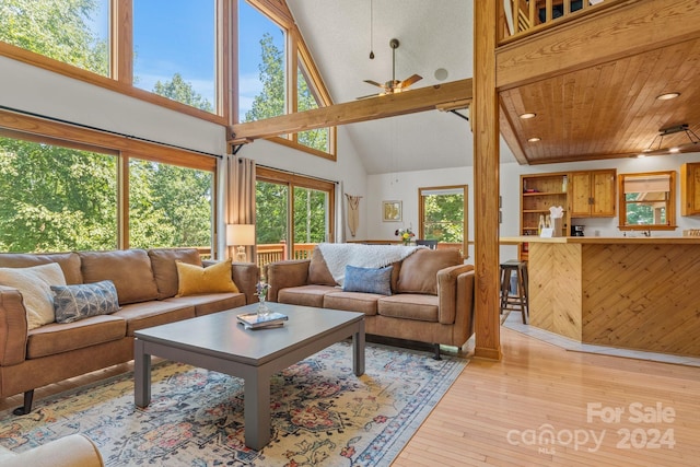 living room featuring a wealth of natural light, light hardwood / wood-style flooring, ceiling fan, and high vaulted ceiling