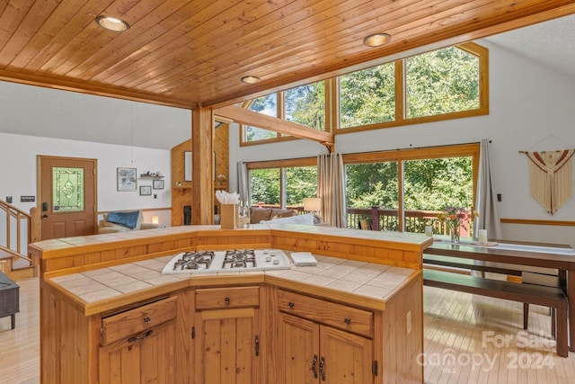 kitchen with wood ceiling, white gas cooktop, tile counters, and light hardwood / wood-style floors