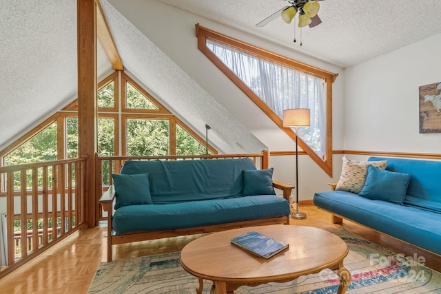 living room with ceiling fan, vaulted ceiling, parquet flooring, and a textured ceiling