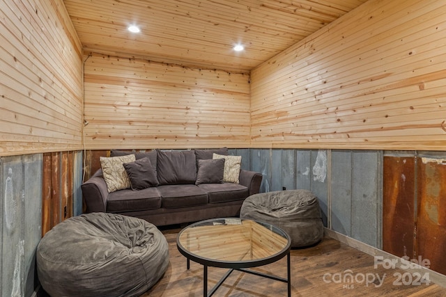 interior space with wood ceiling, hardwood / wood-style floors, and wooden walls