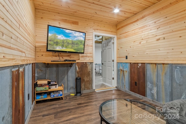 living room featuring dark wood-type flooring, wood walls, and wooden ceiling