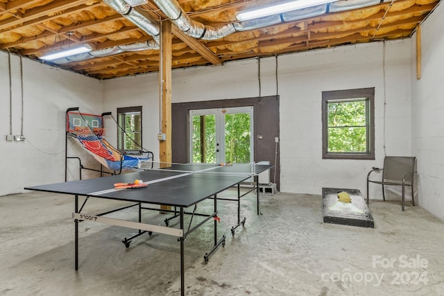 game room with plenty of natural light, concrete floors, and french doors