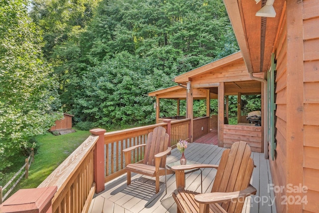 wooden terrace with a storage shed