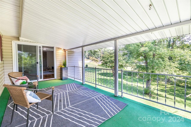 sunroom featuring lofted ceiling