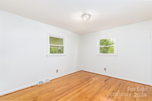 spare room with light hardwood / wood-style floors