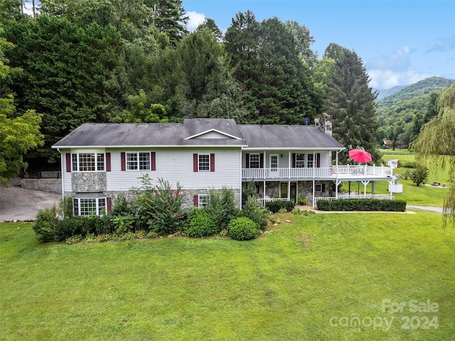 view of front of house with a front lawn and stone siding