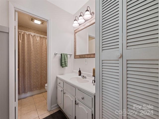 bathroom with toilet, vanity, a shower with shower curtain, and tile patterned flooring