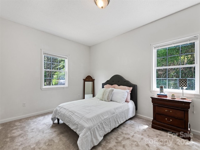 bedroom with carpet flooring and baseboards