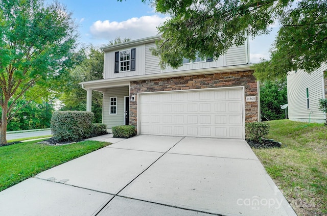 view of front of house featuring a garage and a front lawn