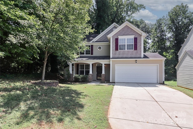 craftsman inspired home with a garage and a front yard