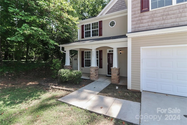 view of front of property featuring a garage and a porch