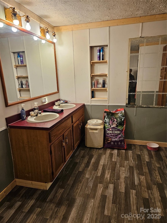 bathroom with a textured ceiling, hardwood / wood-style flooring, and vanity