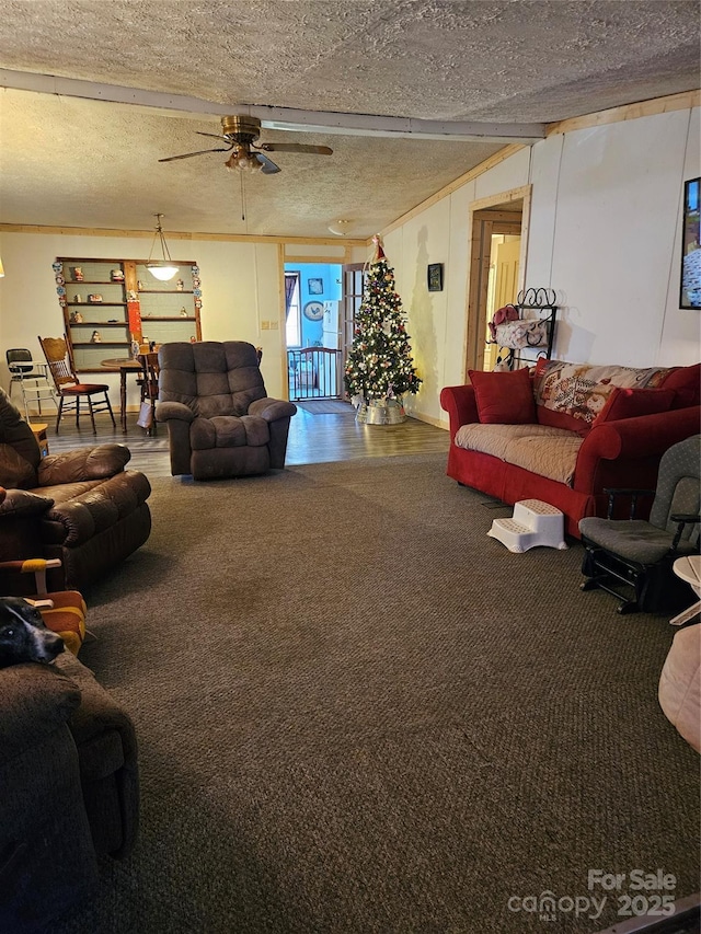 carpeted living room featuring a textured ceiling, ceiling fan, and beam ceiling