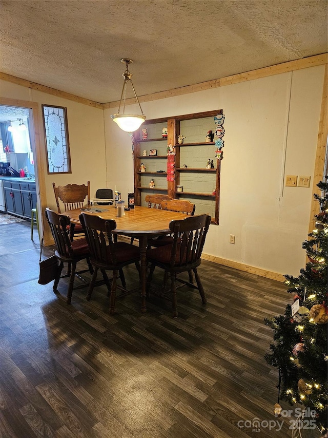 dining area featuring dark hardwood / wood-style floors and a textured ceiling