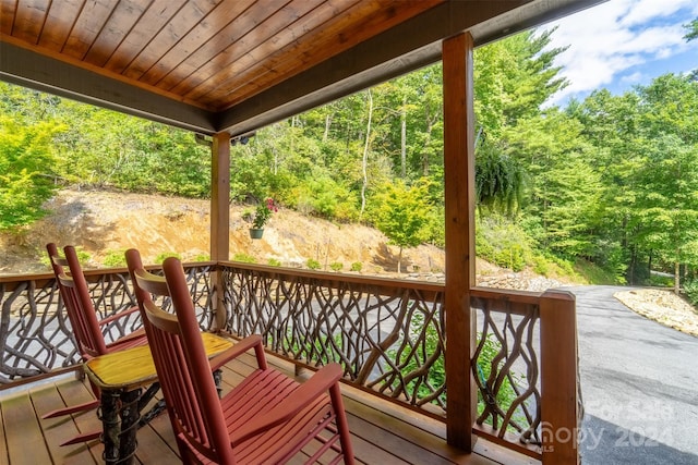 wooden deck with a forest view