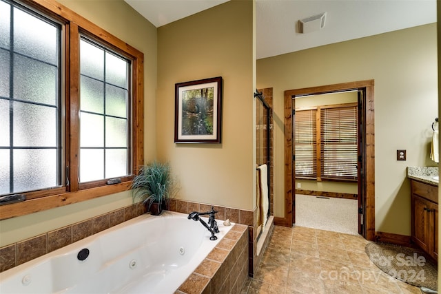 bathroom featuring vanity, tile patterned floors, and shower with separate bathtub