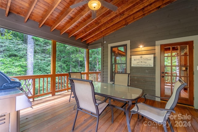 sunroom / solarium with wood ceiling, ceiling fan, and vaulted ceiling with beams