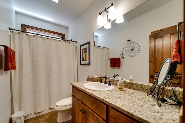 bathroom featuring tile patterned floors, toilet, and vanity