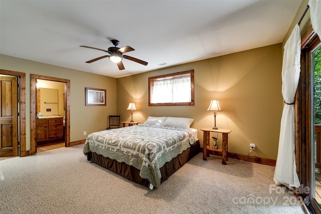 carpeted bedroom featuring a ceiling fan, visible vents, connected bathroom, and baseboards