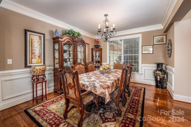 dining area with a notable chandelier, crown molding, and hardwood / wood-style flooring