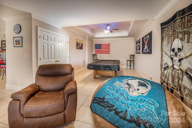 interior space with crown molding, light tile patterned floors, a raised ceiling, and ceiling fan