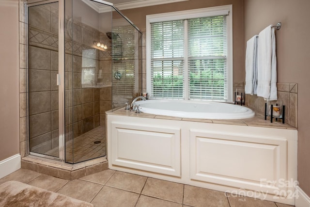 bathroom featuring crown molding, shower with separate bathtub, and tile patterned flooring