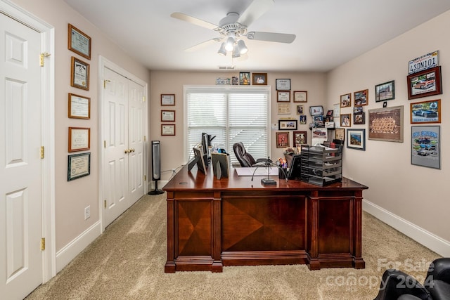 office space with light carpet and ceiling fan