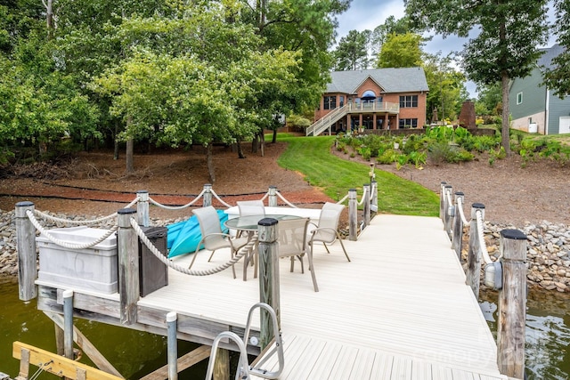 dock area featuring a deck with water view