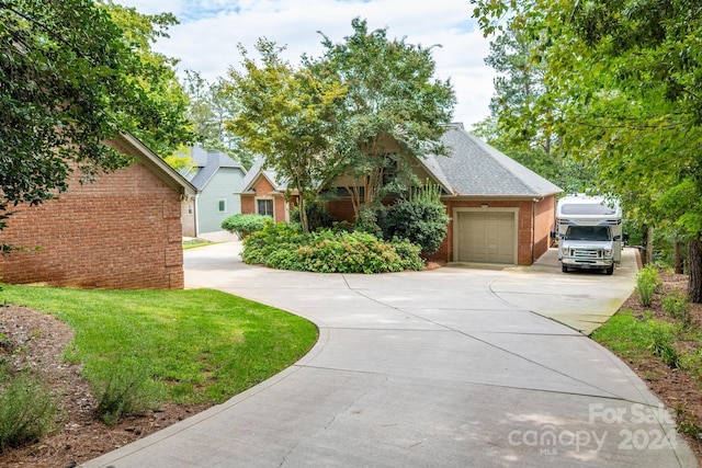 view of front of home with a front yard and a garage