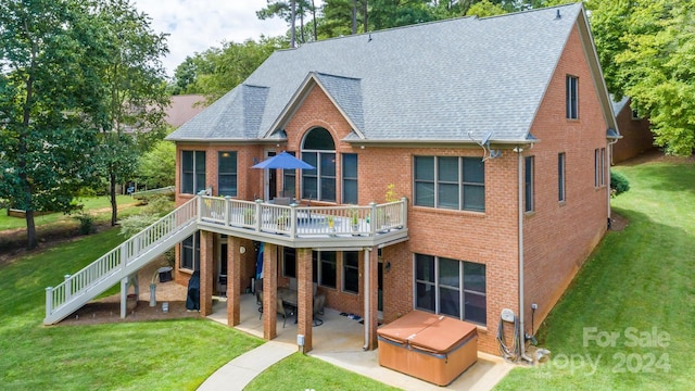 rear view of property featuring a patio area, a deck, and a lawn