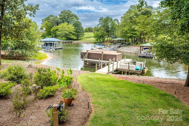 dock area with a yard and a water view