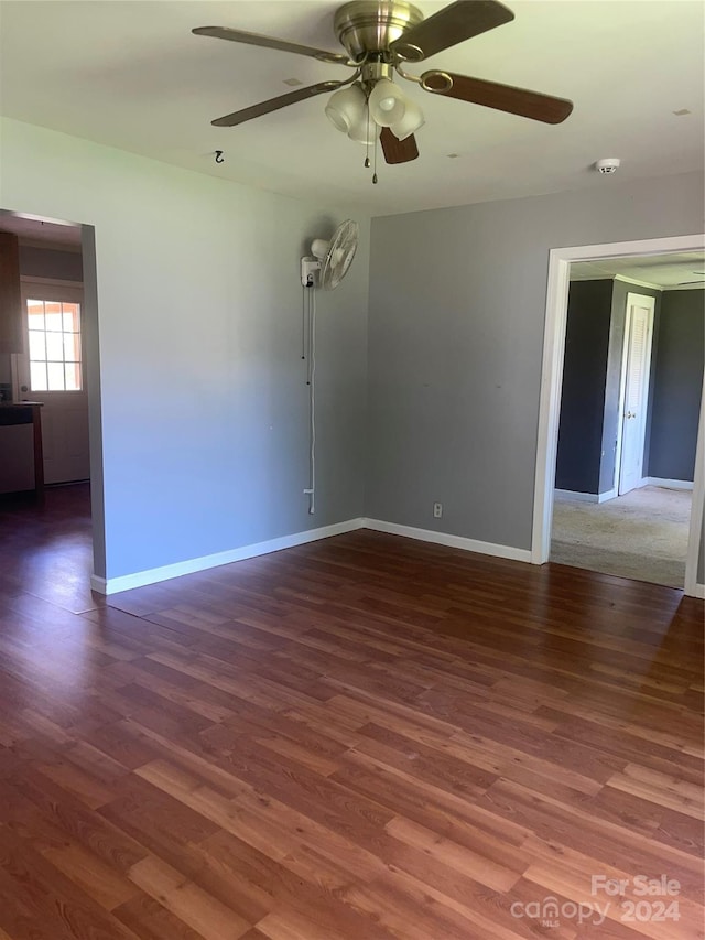 unfurnished room with ceiling fan and dark hardwood / wood-style floors