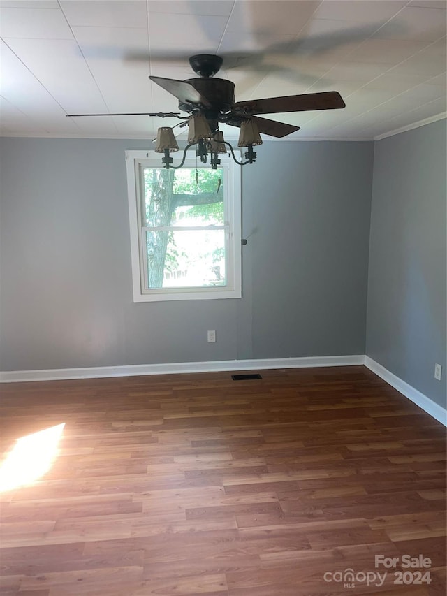 empty room featuring ceiling fan and hardwood / wood-style flooring