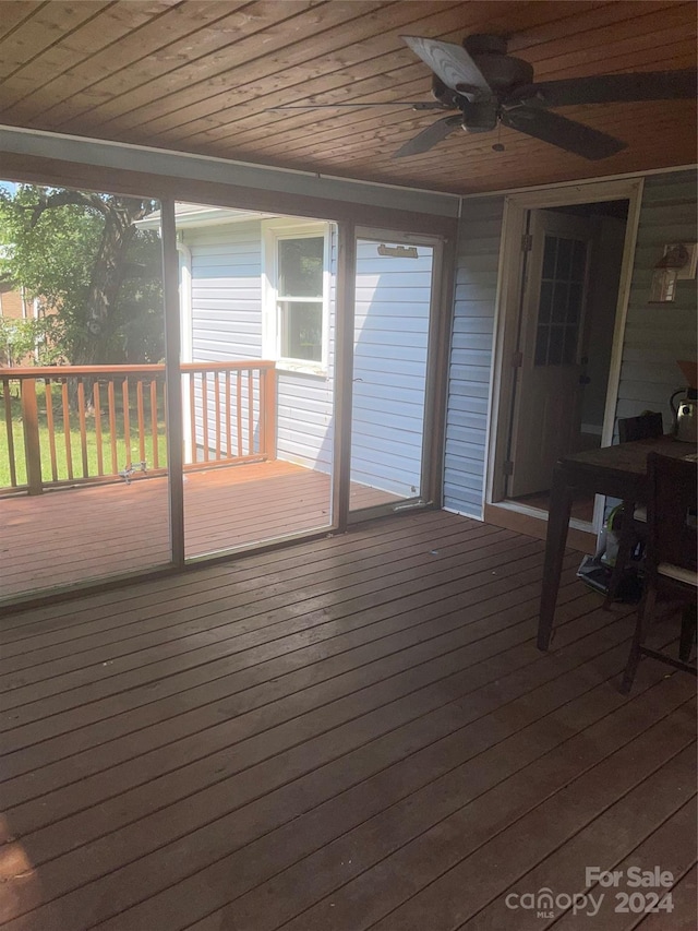 wooden deck featuring ceiling fan