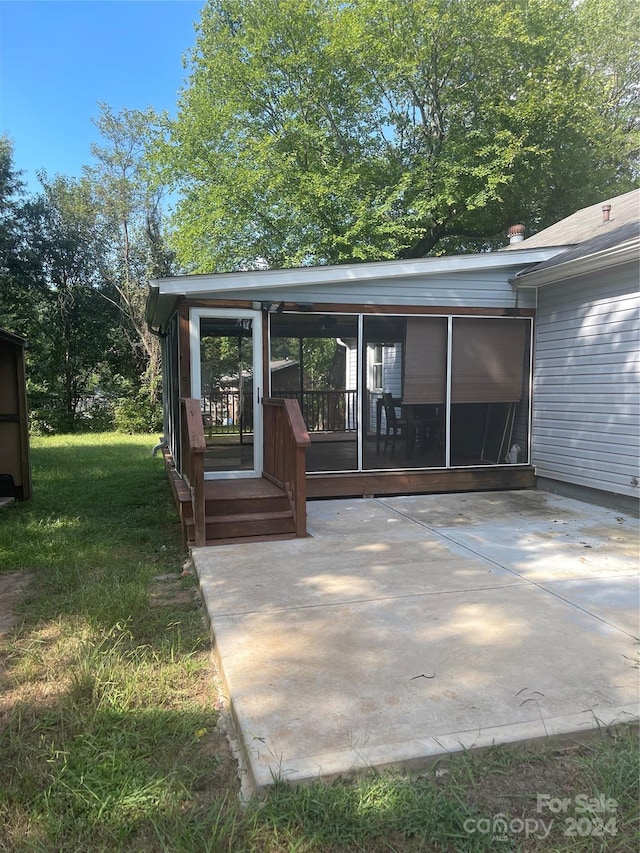 view of patio with a sunroom