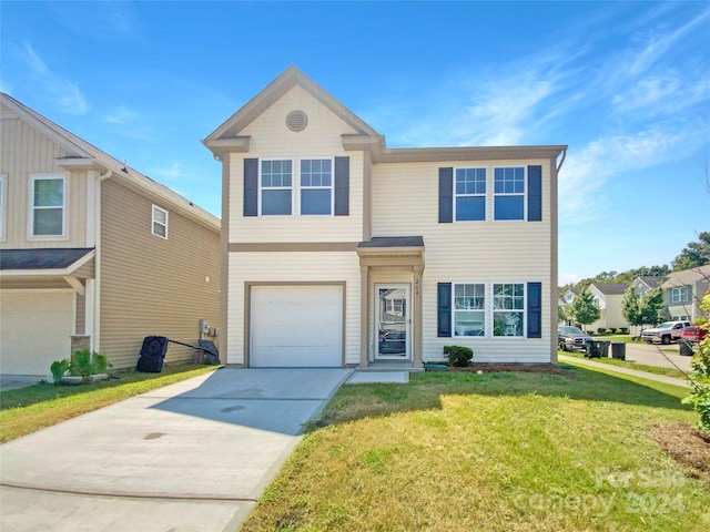 view of front of house featuring a garage and a front lawn