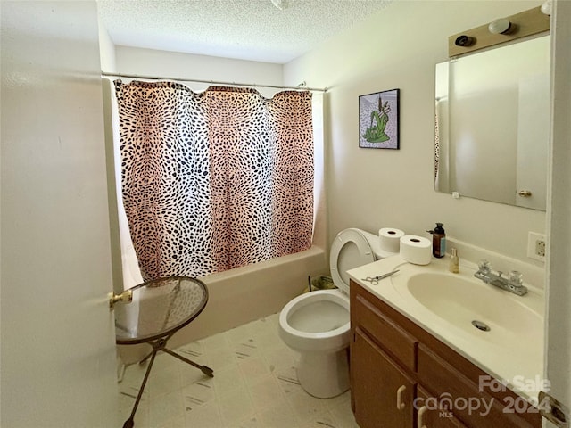 full bathroom with vanity, toilet, a textured ceiling, and shower / bath combo