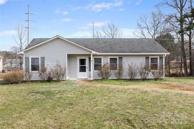 single story home featuring a shingled roof and a front yard