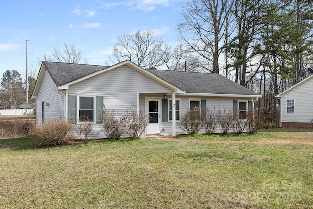 single story home featuring roof with shingles and a front yard