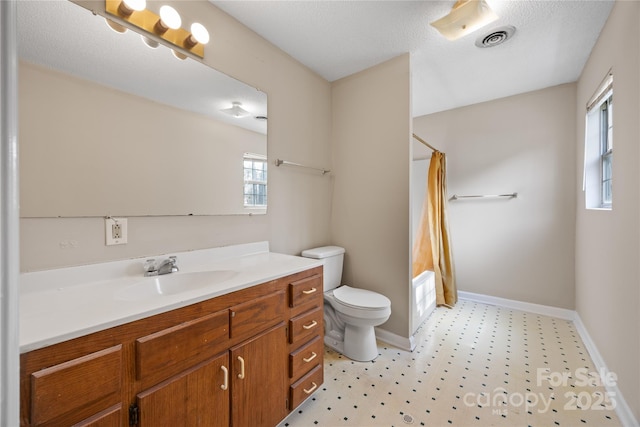 bathroom with toilet, vanity, visible vents, baseboards, and tile patterned floors