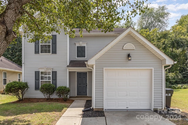 view of front of home featuring a garage and a front yard