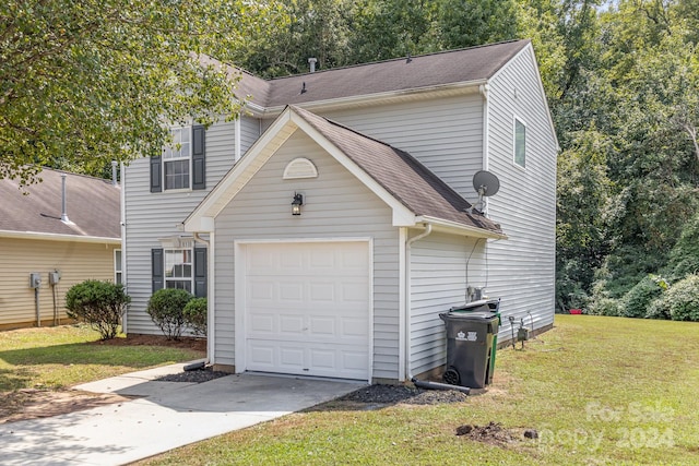 view of front facade with a front yard and a garage