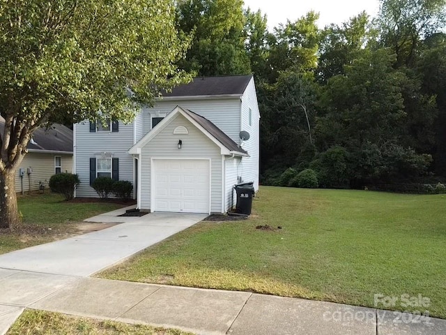 view of front of home featuring a garage and a front lawn