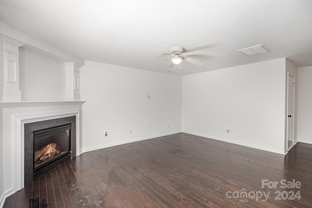 unfurnished living room with dark wood-type flooring and ceiling fan